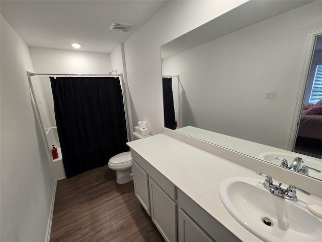 9810 Archdale Spring Dr, Baytown, TX 77521 - bathroom with wood finished floors, toilet, and vanity
