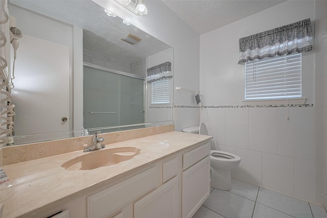 bathroom featuring a shower stall, tile patterned floors, toilet, and vanity