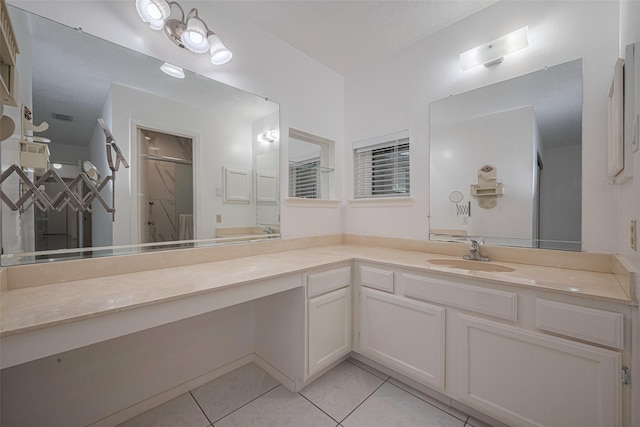 full bathroom featuring tile patterned flooring, vanity, and a shower with door