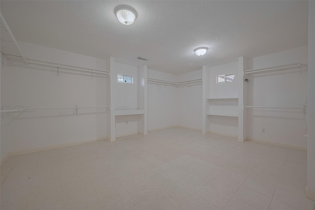 spacious closet with tile patterned floors