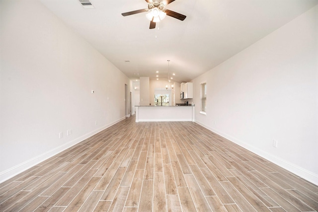 4401 E Bayou Maison Cir, Dickinson, TX 77539 - unfurnished living room with lofted ceiling, light wood-type flooring, a ceiling fan, and baseboards