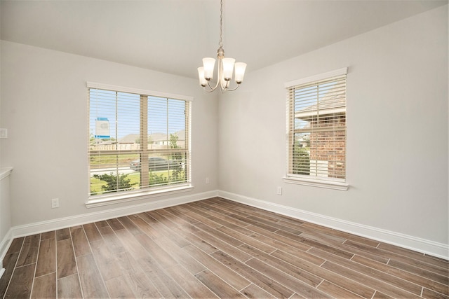 4401 E Bayou Maison Cir, Dickinson, TX 77539 - unfurnished room with a chandelier, wood finished floors, and baseboards
