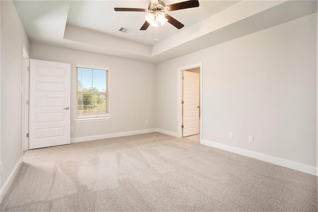 4401 E Bayou Maison Cir, Dickinson, TX 77539 - empty room featuring a raised ceiling, light carpet, baseboards, and ceiling fan