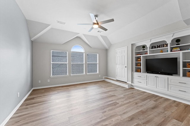 13502 Mount Airy Dr, Cypress, TX 77429 - unfurnished living room with ceiling fan, light wood-style flooring, baseboards, lofted ceiling, and built in shelves