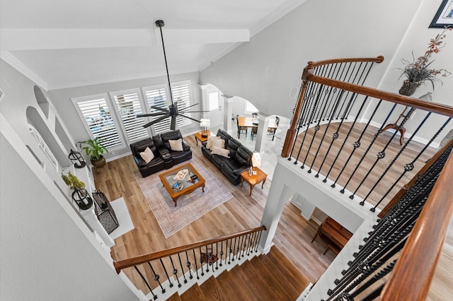 13502 Mount Airy Dr, Cypress, TX 77429 - living room featuring arched walkways, wood finished floors, ornamental molding, ceiling fan, and stairs