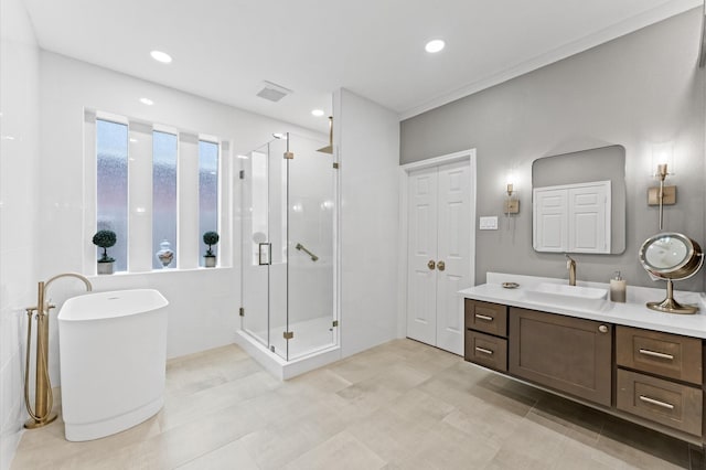 13502 Mount Airy Dr, Cypress, TX 77429 - bathroom with vanity, a shower stall, a freestanding tub, tile patterned flooring, and recessed lighting