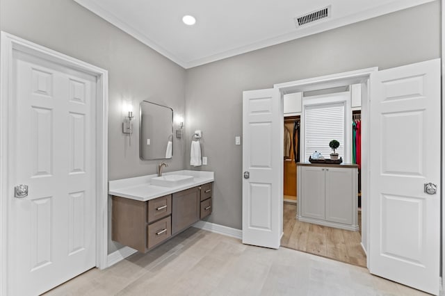 13502 Mount Airy Dr, Cypress, TX 77429 - bathroom with vanity, baseboards, wood finished floors, and ornamental molding