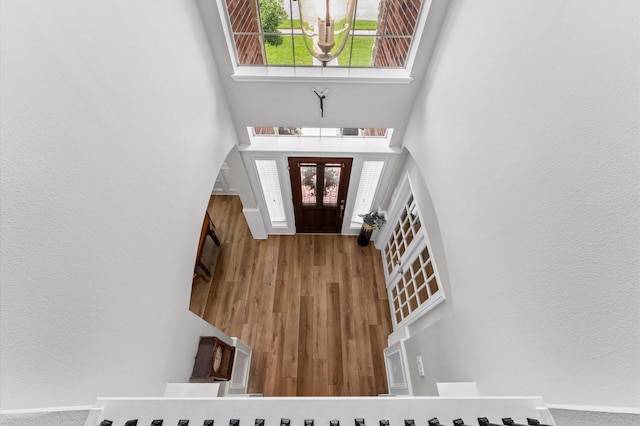 13502 Mount Airy Dr, Cypress, TX 77429 - foyer entrance featuring a towering ceiling, a textured wall, and wood finished floors