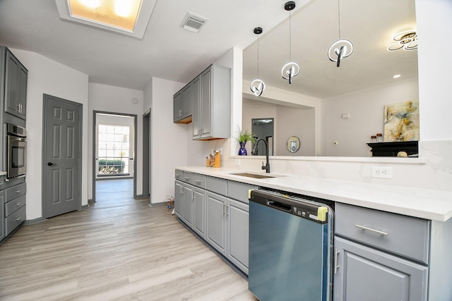 20011 Polly Creek Way, Katy, TX 77450 - kitchen featuring stainless steel appliances, gray cabinets, a sink, and light wood-style flooring