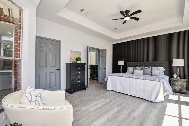 20011 Polly Creek Way, Katy, TX 77450 - bedroom featuring a raised ceiling, light wood-style flooring, crown molding, and ceiling fan