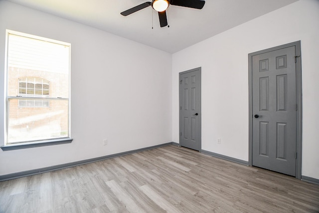20011 Polly Creek Way, Katy, TX 77450 - empty room with light wood-type flooring, a ceiling fan, and healthy amount of natural light