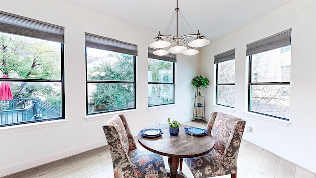 1767 Michigan St, Houston, TX 77006 - dining room featuring a chandelier, light wood-style flooring, and baseboards
