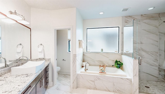 full bath featuring a marble finish shower, a garden tub, toilet, vanity, and marble look tiles