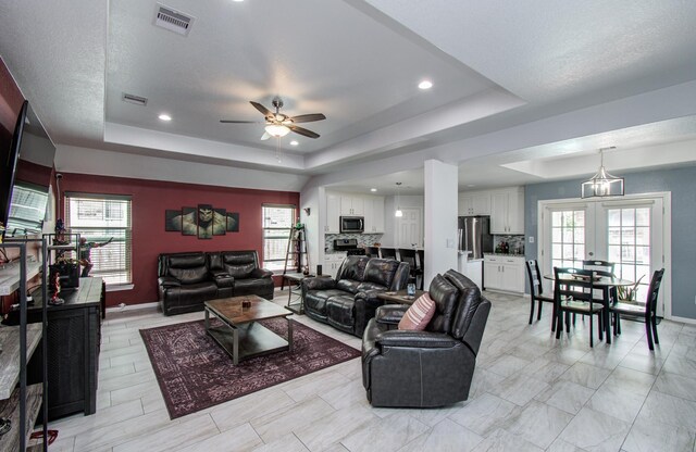 114 Dr Martin Luther King Jr Dr, La Porte, TX 77571 - living area featuring a raised ceiling, a ceiling fan, healthy amount of natural light, french doors, and recessed lighting