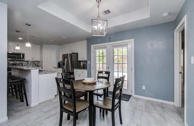 114 Dr Martin Luther King Jr Dr, La Porte, TX 77571 - dining space with french doors, a chandelier, a raised ceiling, and baseboards