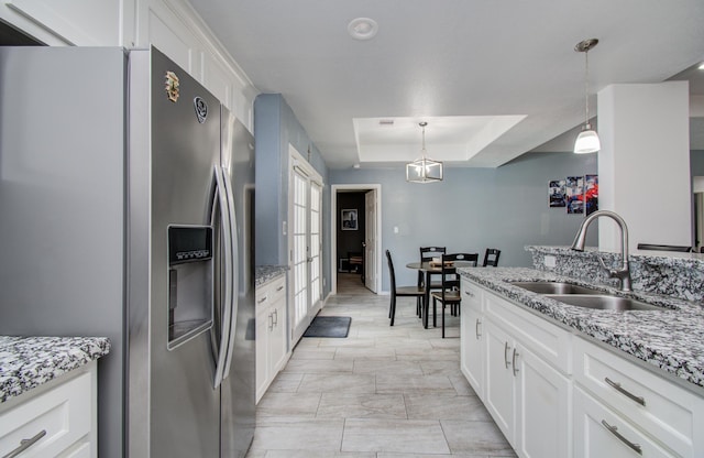 114 Dr Martin Luther King Jr Dr, La Porte, TX 77571 - kitchen with stainless steel fridge, a tray ceiling, a sink, and white cabinetry