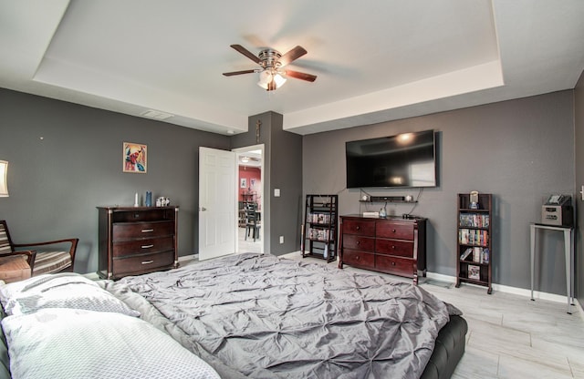 114 Dr Martin Luther King Jr Dr, La Porte, TX 77571 - bedroom featuring baseboards, a tray ceiling, and ceiling fan