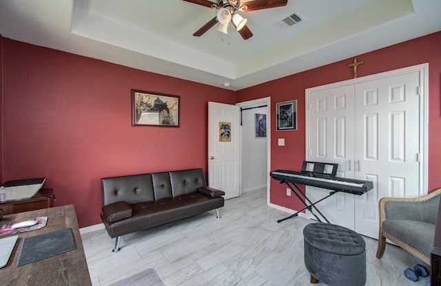 114 Dr Martin Luther King Jr Dr, La Porte, TX 77571 - living area with a raised ceiling, a ceiling fan, and baseboards