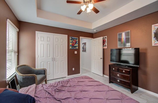 114 Dr Martin Luther King Jr Dr, La Porte, TX 77571 - bedroom with baseboards, a closet, a raised ceiling, and ceiling fan