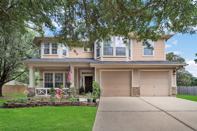 view of front of house featuring a porch, driveway, an attached garage, and stone siding