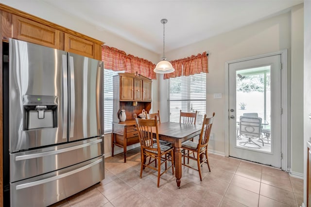 dining area featuring light tile patterned floors and baseboards