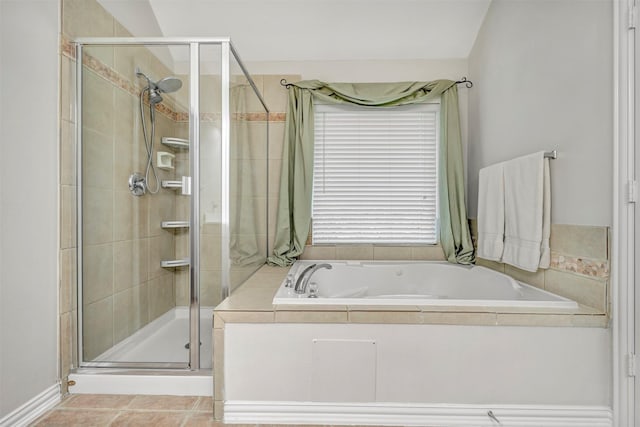 full bathroom featuring a stall shower, a garden tub, and tile patterned floors