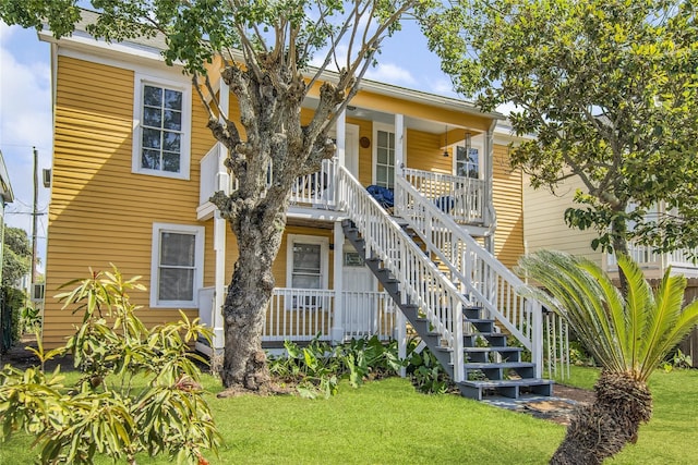 1614 Ursuline St, Galveston, TX 77550 - view of front facade with a porch, stairway, and a front yard