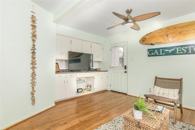 1614 Ursuline St, Galveston, TX 77550 - kitchen featuring light wood-type flooring, ceiling fan, white cabinetry, and baseboards