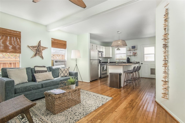 1614 Ursuline St, Galveston, TX 77550 - living area with plenty of natural light, wood finished floors, beamed ceiling, and baseboards