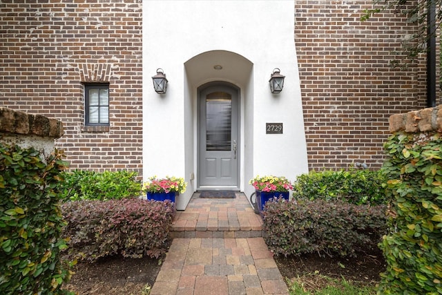 2729 Cohn St, Houston, TX 77007 - doorway to property featuring brick siding and stucco siding