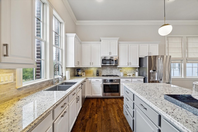 2729 Cohn St, Houston, TX 77007 - kitchen with stainless steel appliances, a sink, white cabinets, crown molding, and dark wood-style floors