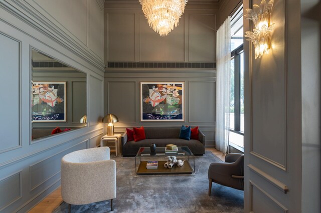home theater featuring a decorative wall and a chandelier