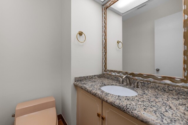 bathroom featuring toilet and vanity