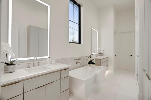 2702 Westgrove Ln, Houston, TX 77027 - bathroom featuring a tub, two vanities, and tile patterned floors