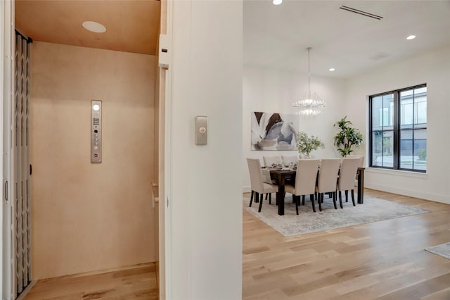 2702 Westgrove Ln, Houston, TX 77027 - dining area with wood finished floors, recessed lighting, a chandelier, and elevator