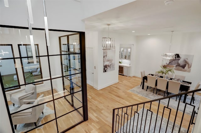 2702 Westgrove Ln, Houston, TX 77027 - corridor featuring a chandelier, wood finished floors, and baseboards