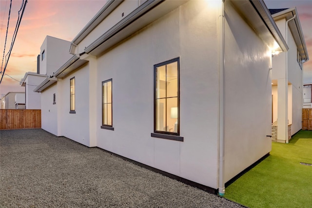 2702 Westgrove Ln, Houston, TX 77027 - property exterior at dusk featuring stucco siding and a patio area