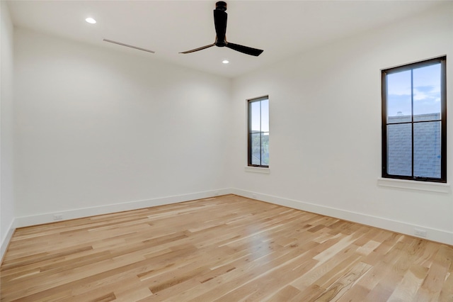 2702 Westgrove Ln, Houston, TX 77027 - empty room featuring healthy amount of natural light, light wood-style floors, a ceiling fan, baseboards, and recessed lighting