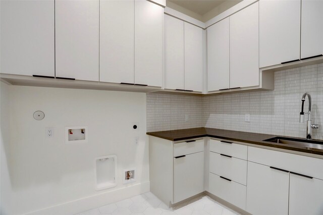 2702 Westgrove Ln, Houston, TX 77027 - laundry area with electric dryer hookup, washer hookup, cabinet space, hookup for a gas dryer, and baseboards