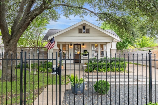 741 E 13th 1/2 St, Houston, TX 77008 - view of front of house with covered porch, a shingled roof, a fenced front yard, and a gate