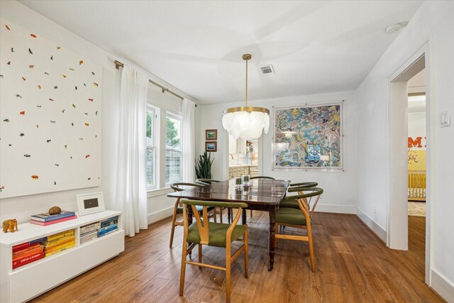 741 E 13th 1/2 St, Houston, TX 77008 - dining space featuring light wood-type flooring, baseboards, and a chandelier