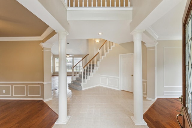 1301 Wilderness Pines Dr, Friendswood, TX 77546 - entrance foyer featuring a decorative wall, stairway, ornate columns, crown molding, and ceiling fan