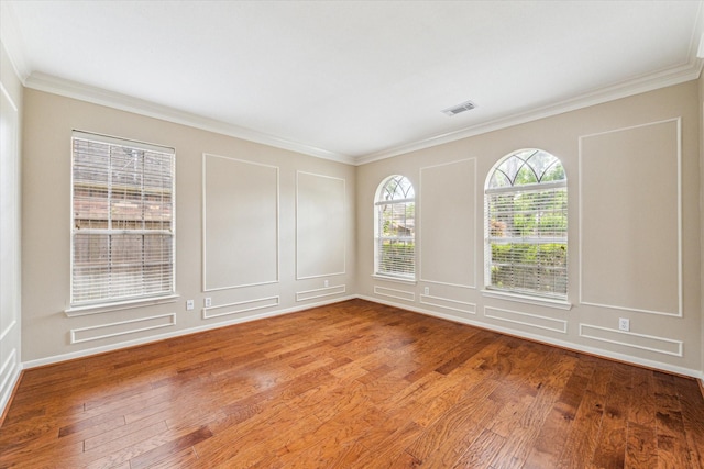 1301 Wilderness Pines Dr, Friendswood, TX 77546 - spare room with wood finished floors, ornamental molding, and a decorative wall