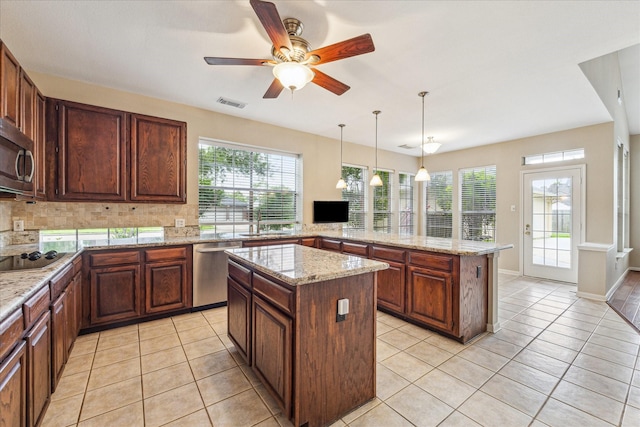 1301 Wilderness Pines Dr, Friendswood, TX 77546 - kitchen with stainless steel appliances, a center island, plenty of natural light, and a sink
