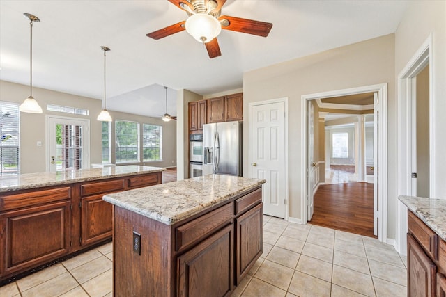 1301 Wilderness Pines Dr, Friendswood, TX 77546 - kitchen with appliances with stainless steel finishes, ceiling fan, light tile patterned floors, hanging light fixtures, and a kitchen island