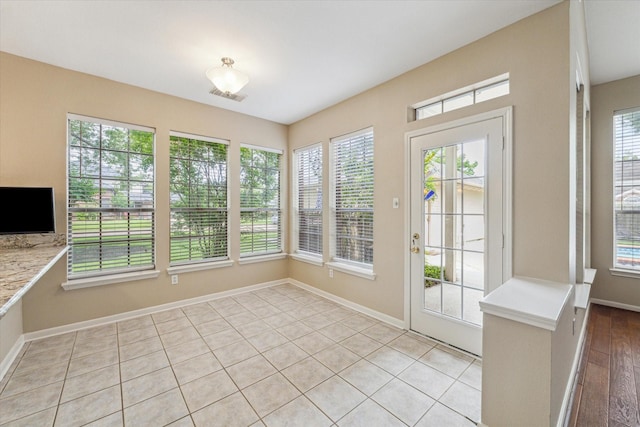 1301 Wilderness Pines Dr, Friendswood, TX 77546 - unfurnished sunroom with baseboards and tile patterned flooring
