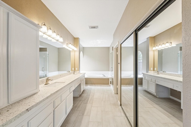 1301 Wilderness Pines Dr, Friendswood, TX 77546 - full bath featuring two vanities and a garden tub