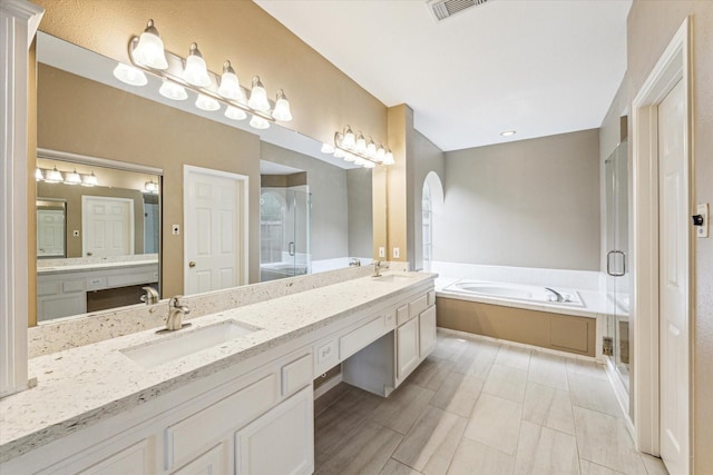 1301 Wilderness Pines Dr, Friendswood, TX 77546 - full bath with a garden tub, double vanity, and a stall shower