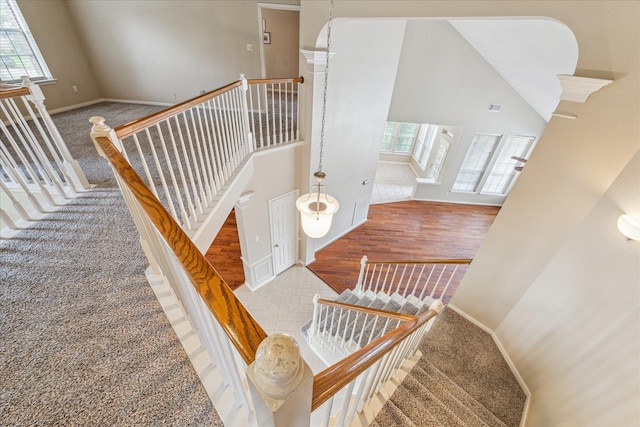 1301 Wilderness Pines Dr, Friendswood, TX 77546 - stairway with a high ceiling, baseboards, and tile patterned floors