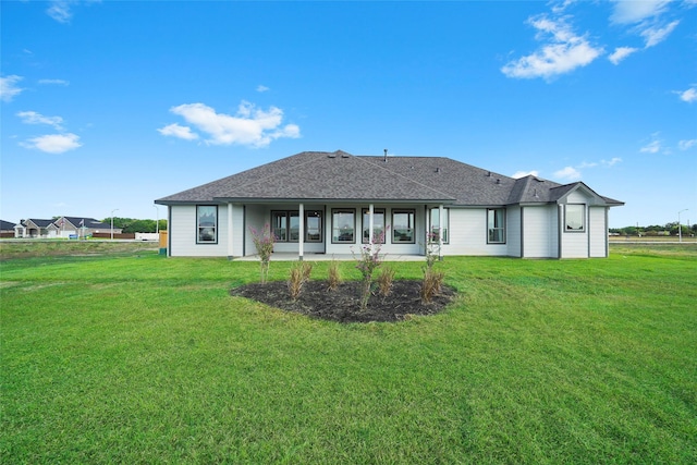 11034 Moon Light Dr, Needville, TX 77461 - rear view of property featuring a lawn and roof with shingles
